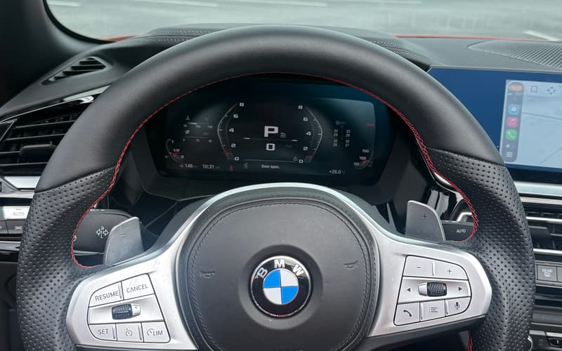 Driver view through the M Sport steering wheel to the digital instrument cluster