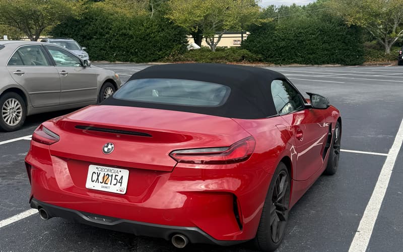 2024 BMW Z4 rear three-quarter view showing the soft top, LED tail lights and dual exhaust