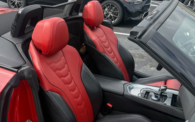Red and black leather sport seats with the roof open